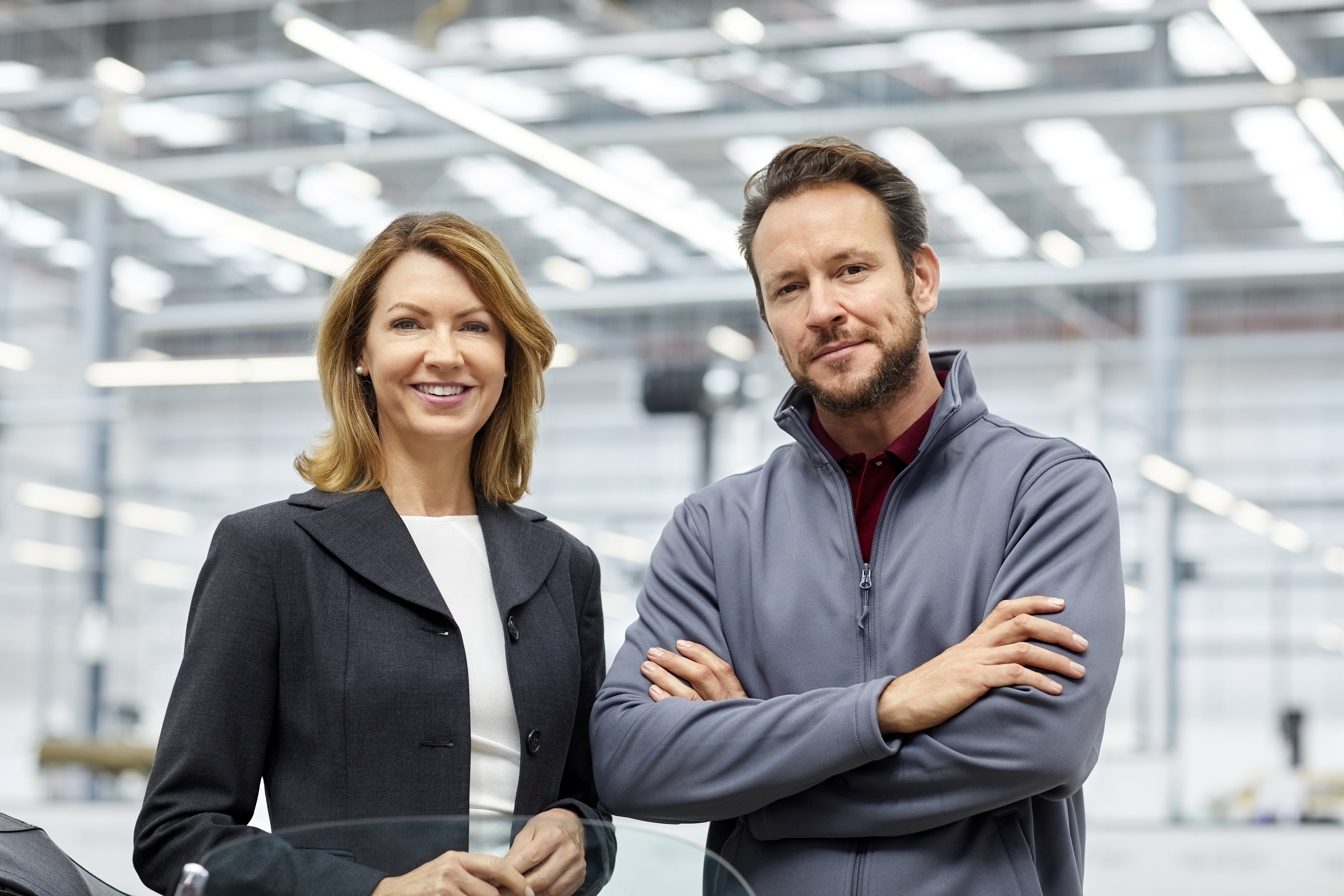 Professionals are smiling by vintage car