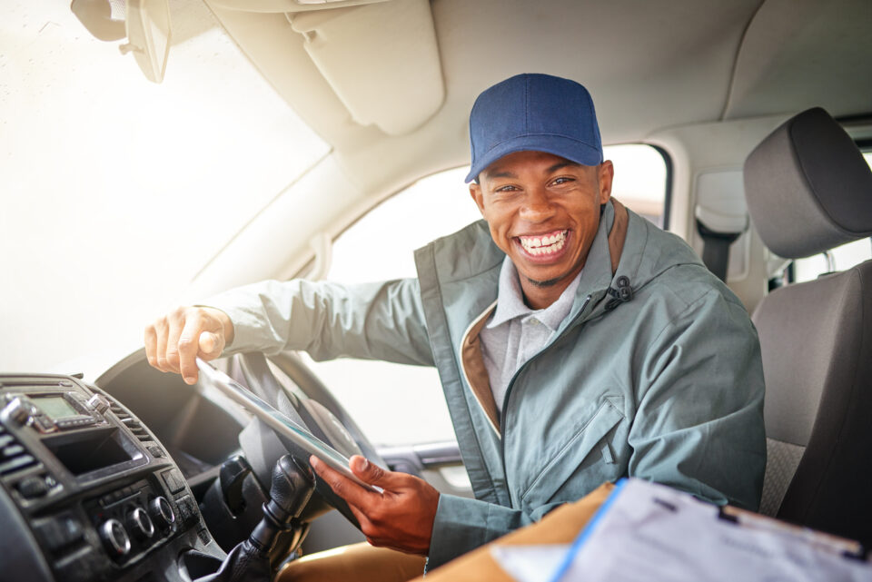 Portrait of a courier driving a delivery van